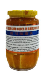 Jar of pickled bean curd cubes in brine.