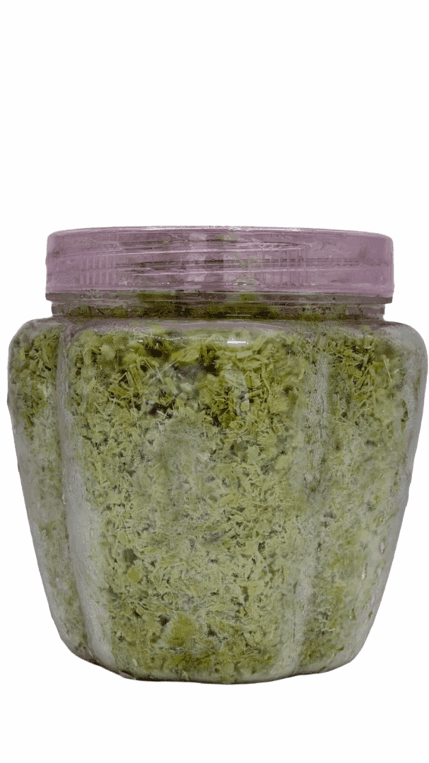 Clear jar with green dried contents.